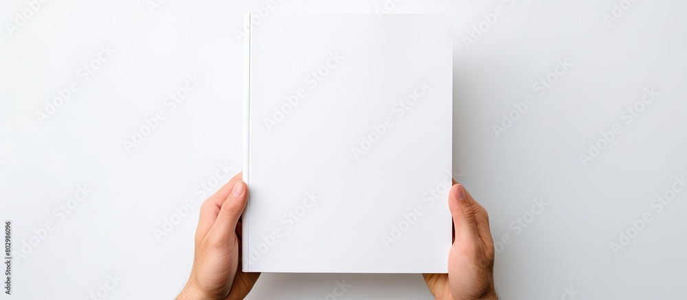 Poster a copy space image of a white background featuring a person holding a blank notebook