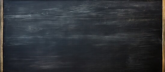 A blackboard with chalk marks erased leaving empty space for new information commonly known as copy space image