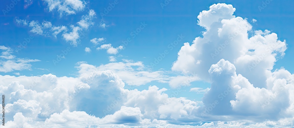 Poster a copy space image with a backdrop of a clear blue sky dotted with fluffy white clouds