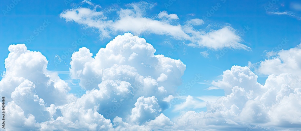 Poster a copy space image with a backdrop of a clear blue sky dotted with fluffy white clouds
