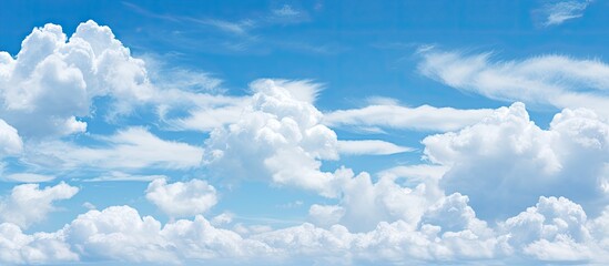 A background of partly cloudy blue sky with ample copy space image