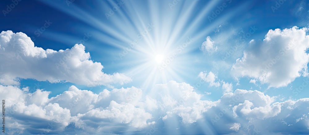 Poster a copy space image of sunlight filtering through white clouds against a blue sky backdrop