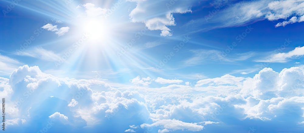 Poster a copy space image of sunlight filtering through white clouds against a blue sky backdrop