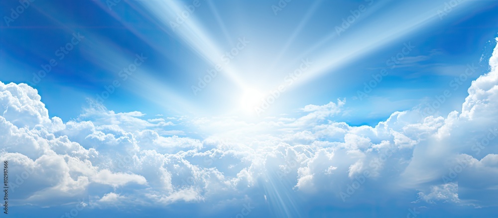 Poster a copy space image of sunlight filtering through white clouds against a blue sky backdrop