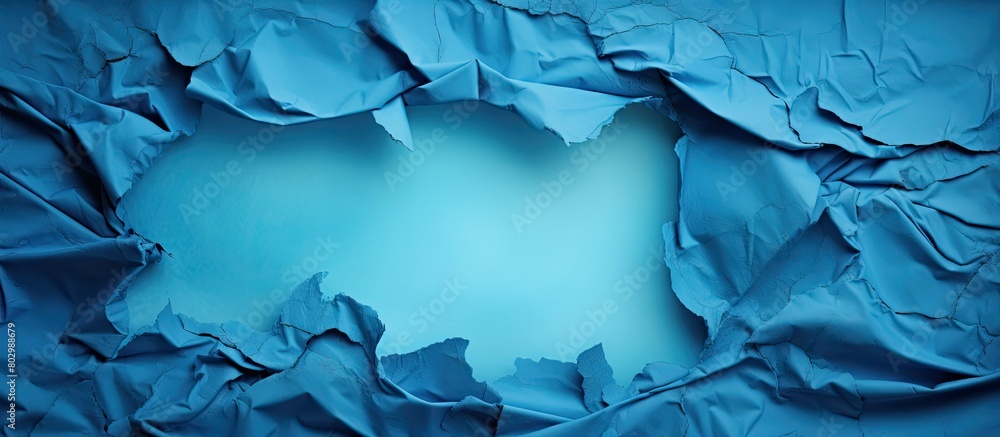 Poster a blue sheet with a torn and worn texture revealing a hole the sheet has a painted surface and offer