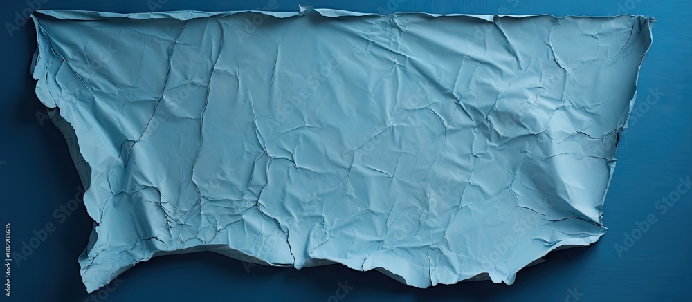 Poster a blue sheet with a torn and worn texture revealing a hole the sheet has a painted surface and offer
