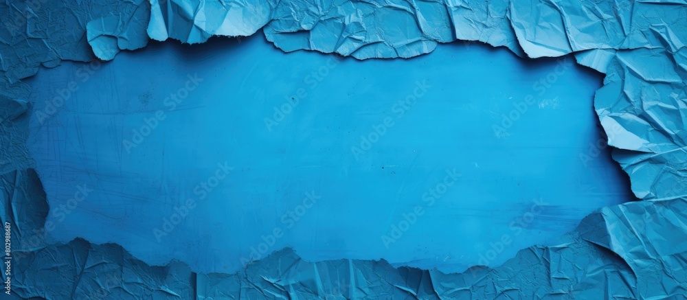 Aufkleber A blue sheet with a torn and worn texture revealing a hole The sheet has a painted surface and offers copy space for text