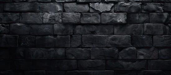 A dark wallpaper featuring a textured old black brick wall providing a design friendly copy space image