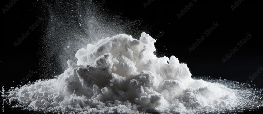 Poster a black background hosts a striking image of white chalk powder providing copy space for textures or