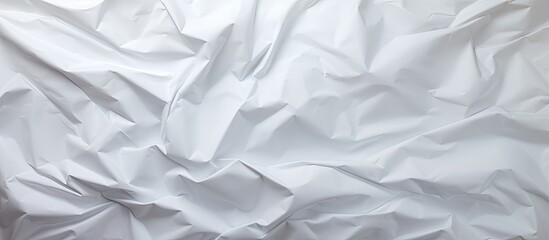 A crumpled white paper creates a textured and vintage backdrop for web design screensavers leaving space for images. with copy space image. Place for adding text or design