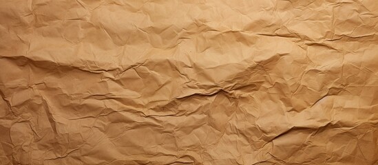 Fototapeta premium A background image with the texture of crumpled and creased brown paper resembling an abstract copy space image