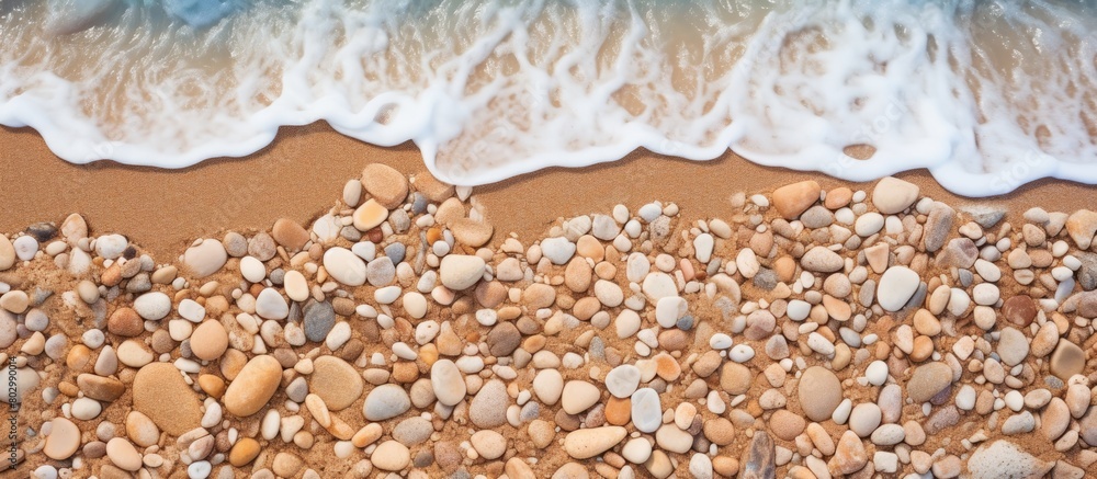 Poster a close up of a beautiful textured background on a summer beach with sand and small stones near the 