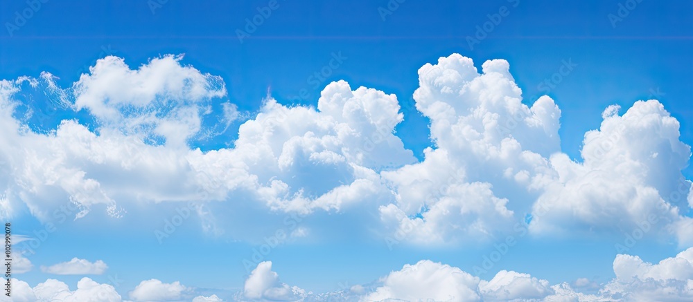 Poster a background image featuring a clear blue sky adorned with fluffy white clouds copy space available