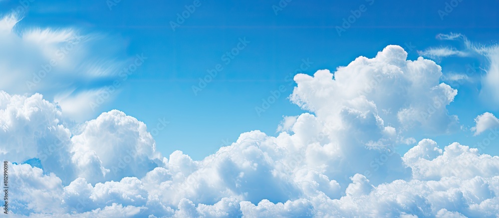 Poster a background image featuring a clear blue sky adorned with fluffy white clouds copy space available