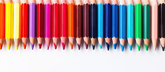 A copy space image showcasing colorful pencils placed on a white backdrop