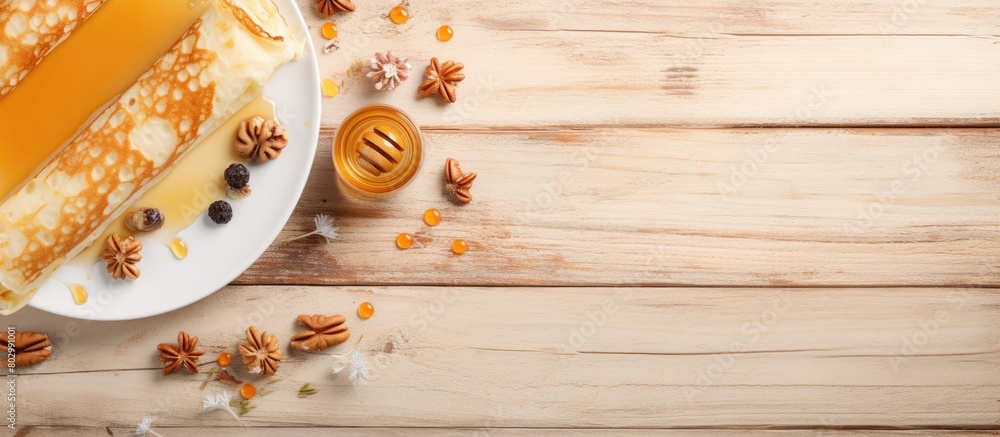 Poster a copy space image of crepes honey and nuts on a white plate placed on a wooden background