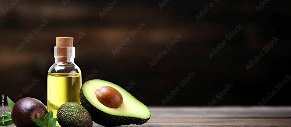 Aufkleber A bottle of essential oil a pipette and a fresh avocado are placed on a wooden table creating a copy space image