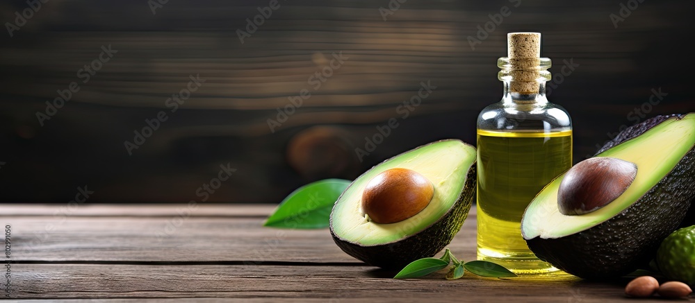 Aufkleber A bottle of essential oil a pipette and a fresh avocado are placed on a wooden table creating a copy space image