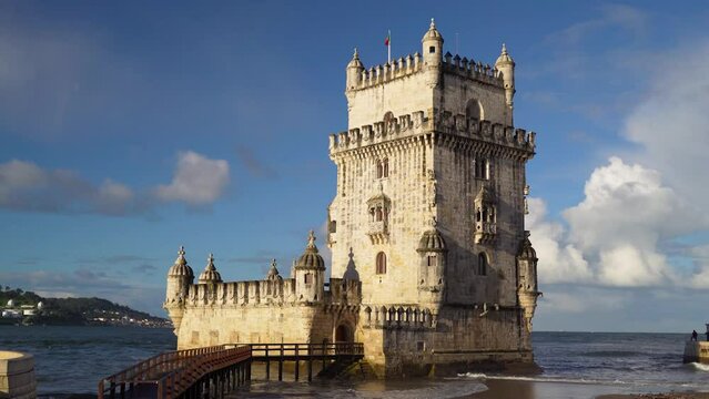 Belem Tower Lisbon without tourist on sunrise with waves and clouds