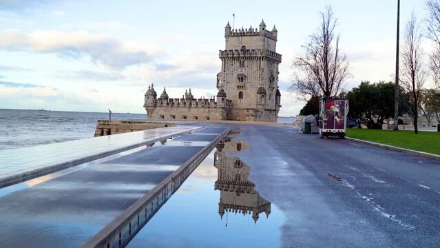 Reflection of Belem Tower on wet street after rain in Lisbon