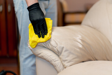 close up professional apartment cleaning cleaner to wipe the leather part of the sofa