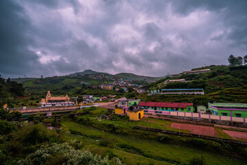 Nilgiris beauty of Ooty tea estates, where emerald-green fields meet the rolling clouds, creating a...