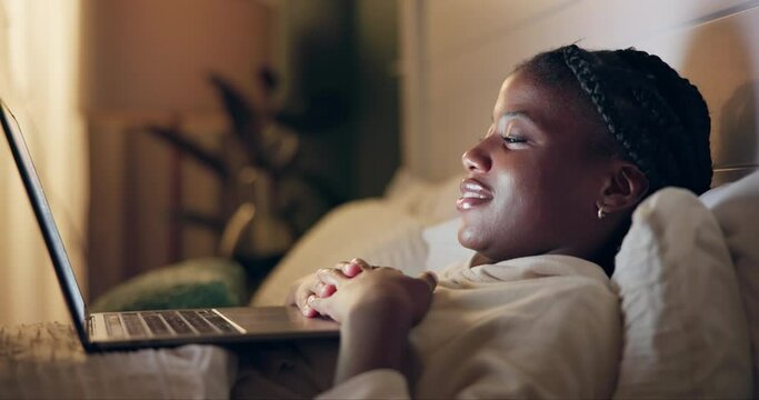 Bed, watch and black woman on laptop for movie streaming service, film or comedy at night. Girl at home relax in bedroom with computer for online TV show, series and funny video on weekend or holiday