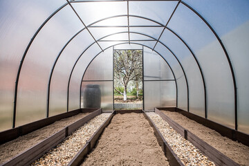 A new greenhouse made of polyethylene and polycarbonate with new beds made of Wood-polymer...