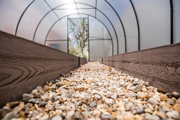 A new greenhouse made of polyethylene and polycarbonate with new beds made of Wood-polymer...