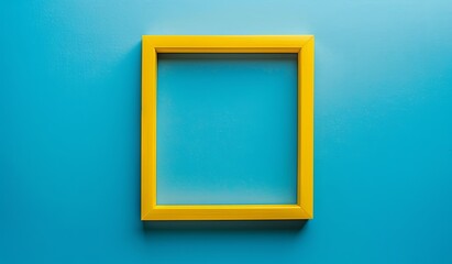 Vibrant yellow picture frame on a blue wall