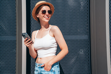 Young beautiful smiling hipster woman in trendy summer casual clothes. Carefree woman posing in the...