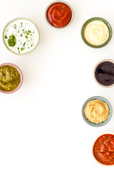 Many different sauces in bowls. Food or cooking background