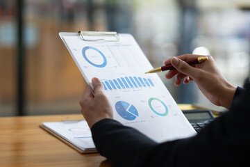 Businessman working on paperwork is analyzing business financial statistics.