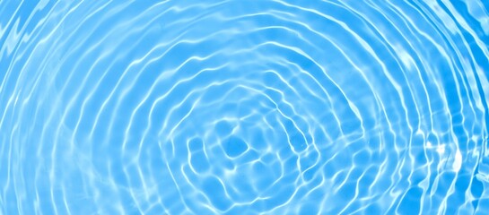 Abstract blue water ripple surface. Transparent clear water wave on blue background. Sunlight on...