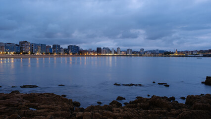 Sunset and lighting of lights in a coastal city of the Cantabrian Sea. Gijon - Asturias