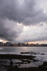 Imposing clouds are heading towards the coastal city. Adverse and autumnal weather concept.
