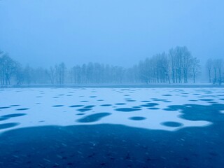 Fototapeta premium frozen snowy pond in the winter park