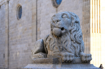 Ancient lion statue. Medieval cathedral architecture building in Avila, Spain