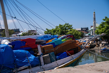 Furniture and other equipment were loaded into a wooden boat at Paotere Traditional Harbour.