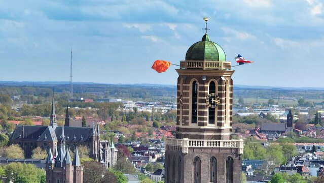 Zwolle Peperbus church tower with Dutch and Orange flags in the wins during Koningsdag 