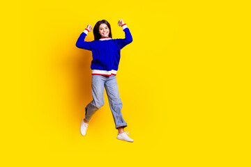 Full length photo of pretty teen girl jumping winning wear trendy knitwear blue outfit isolated on...