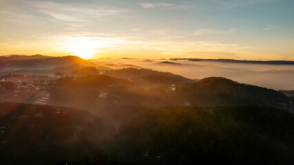 Dalat City at dawn, dusk, shrouded in mist, with diverse architecture amidst verdant greenery,...