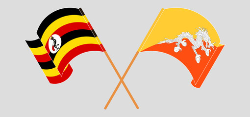 Crossed and waving flags of Uganda and Bhutan