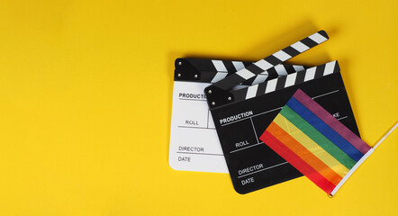 Two Clapper board and rainbow pride flag on yellow background.