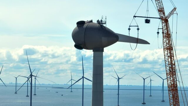 Wind turbine construction works with rows of wind turbines in an offshore windpark in The Netherlands.