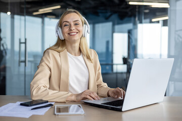 Smiling businesswoman in headphones during a video call