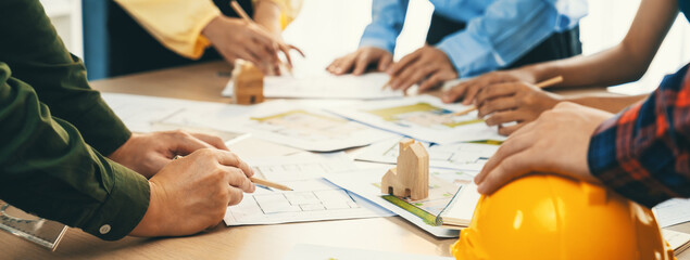 Professional architect team and engineer discuss about architectural project on meeting table with...