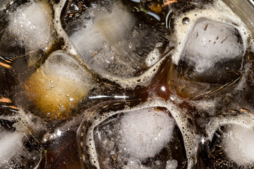 Ice cold black coffee with foam and bubbles horizontal macro photography
