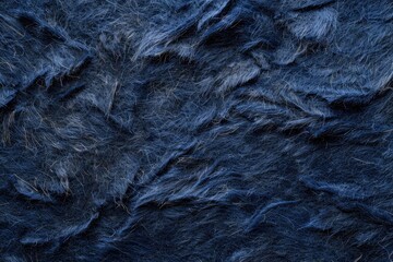 An electric blue, crumpled paper with a grey pattern in the darkness