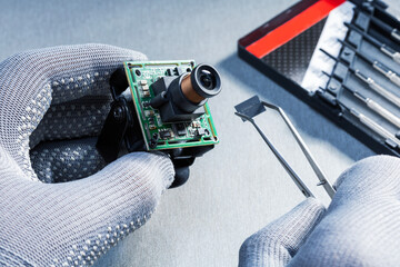 Technician repairs CCTV camera. Repair concept, service, CCTV, camera.